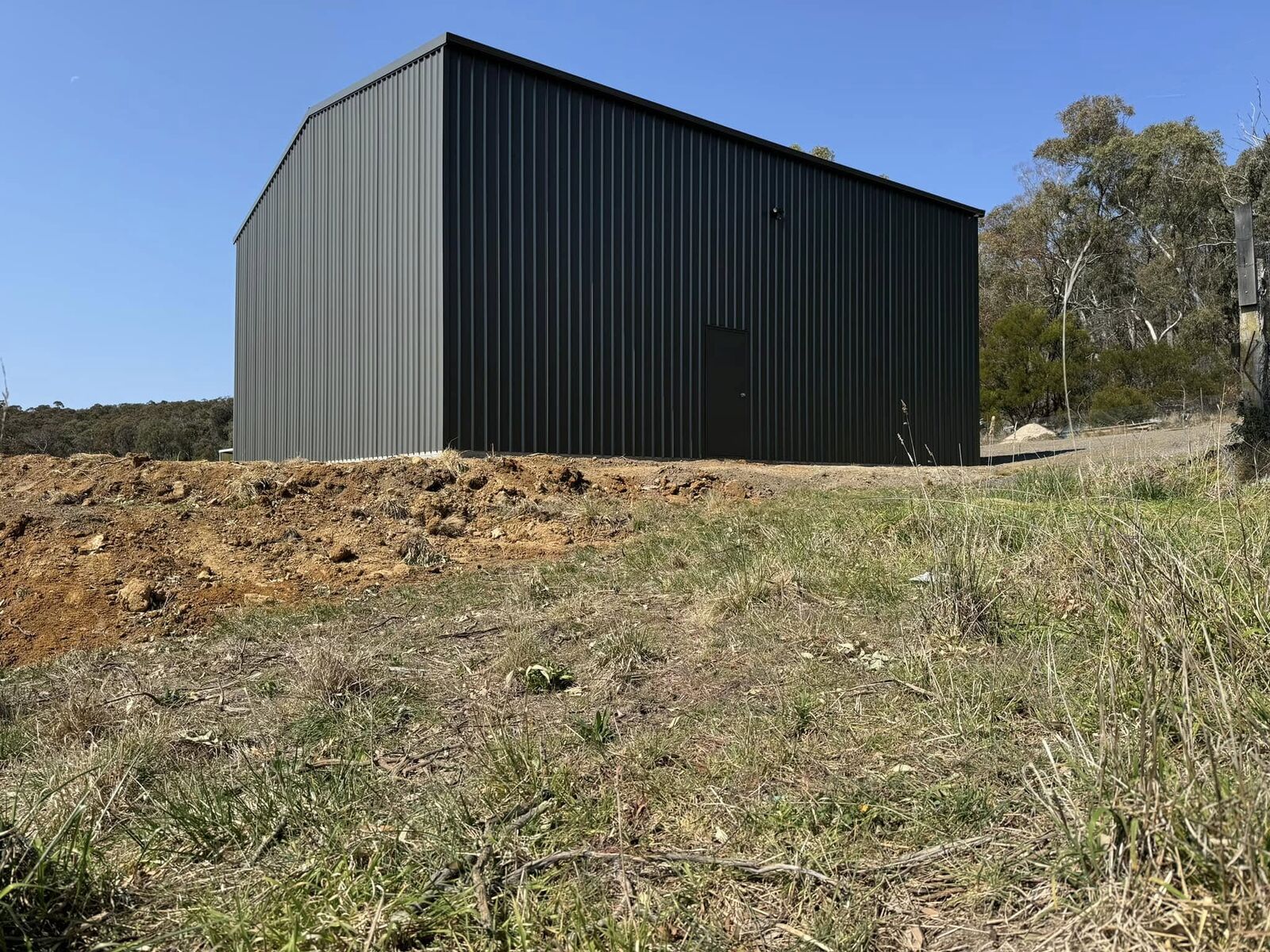 Charcoal Colorbond steel shed built on a rural acreage block